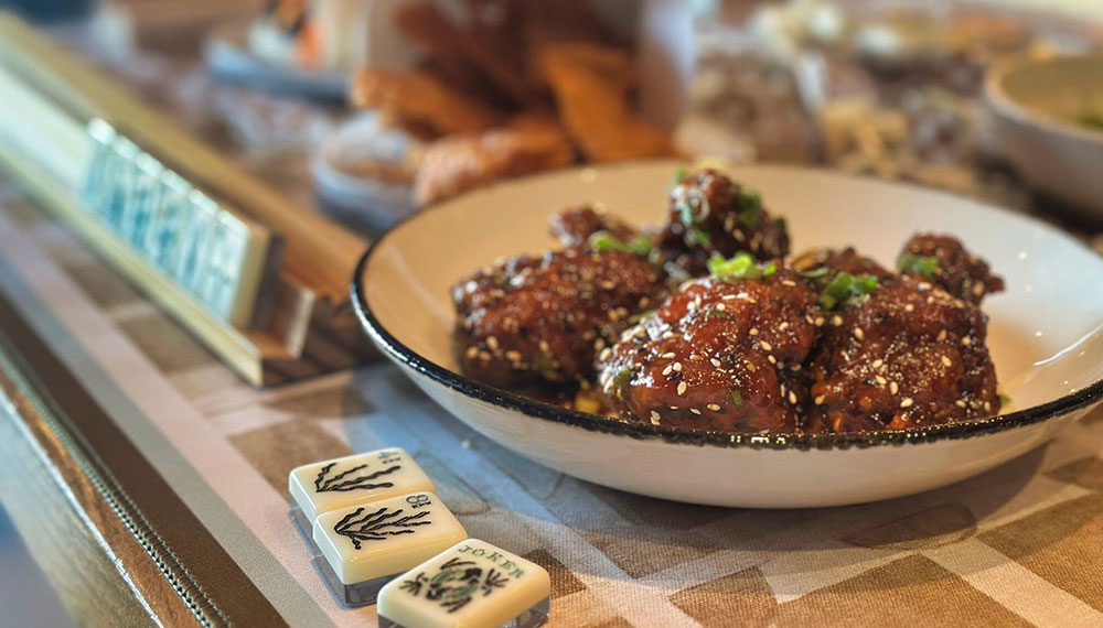 close up of food dish and mahjong tiles